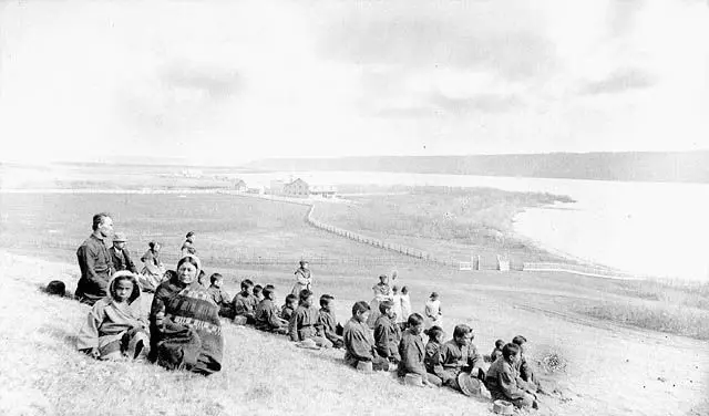 Students and staff of the Fort Qu'Appelle Industrial School on a hillside above the lake