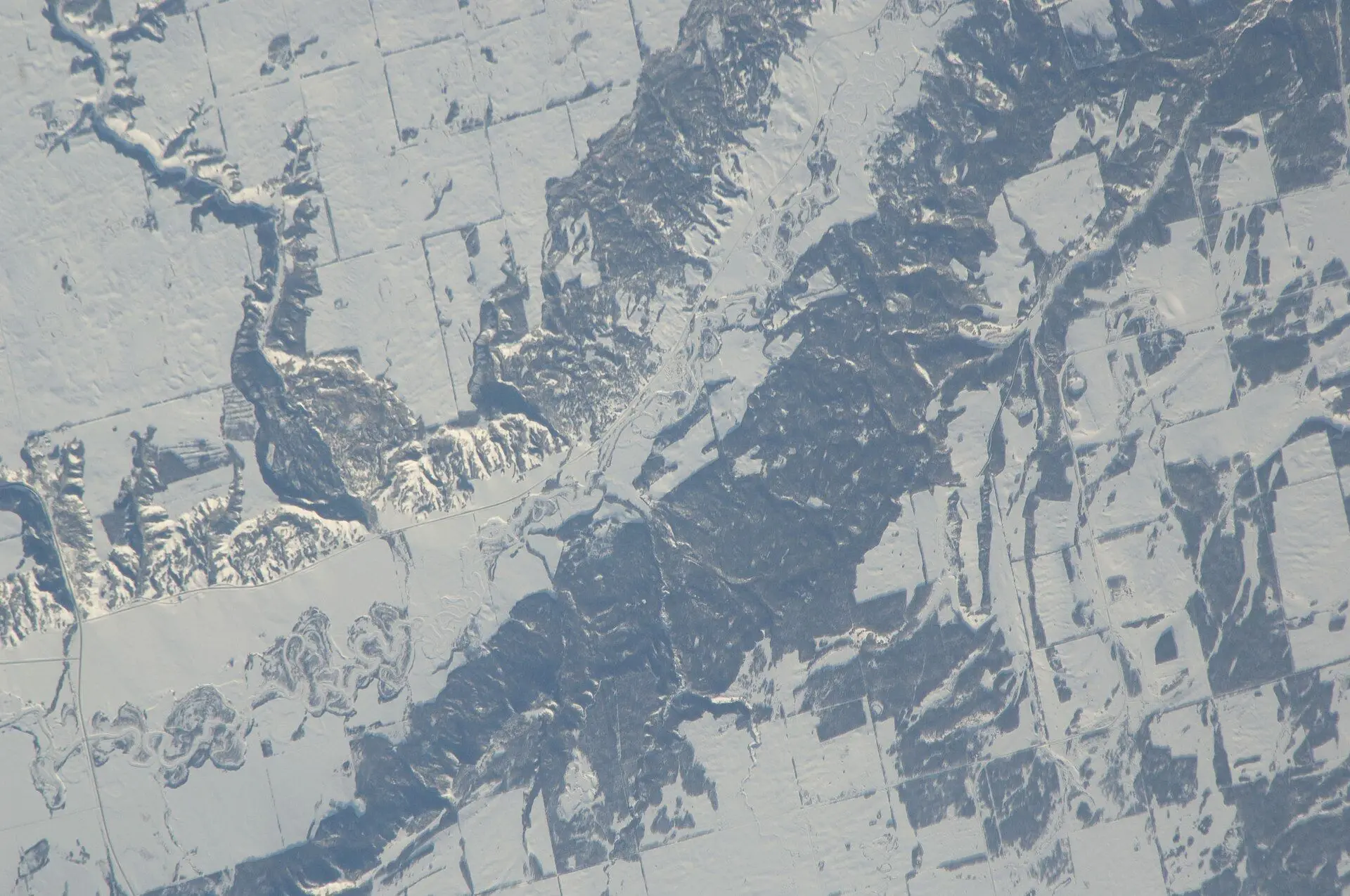 Snowy valley and farmland seen from space