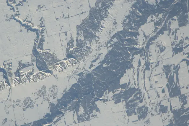 Snowy valley and farmland seen from space